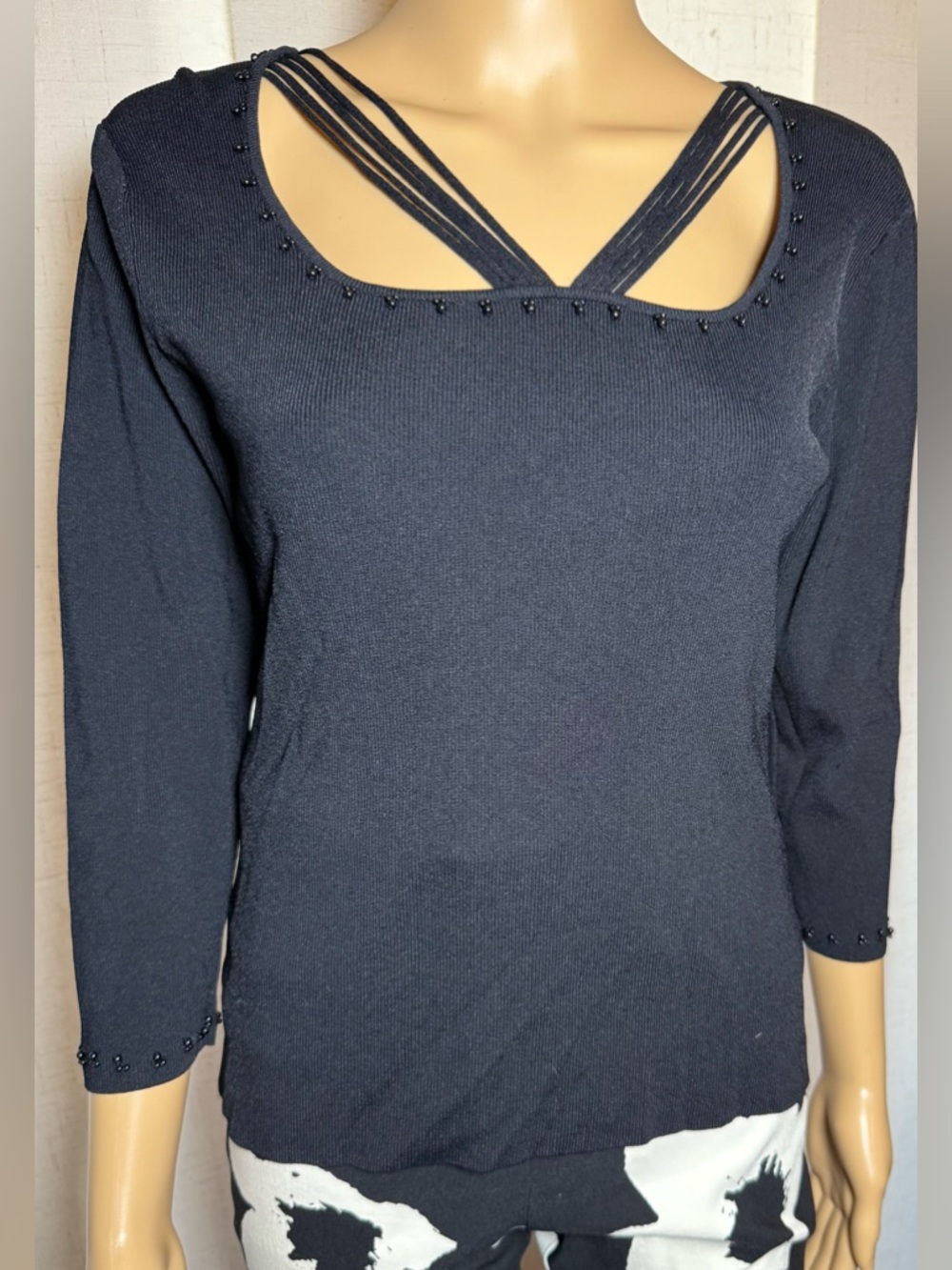 Finity black 3/4 length sleeve top. Beaded neck & cuffs. Strappy decolletage.
